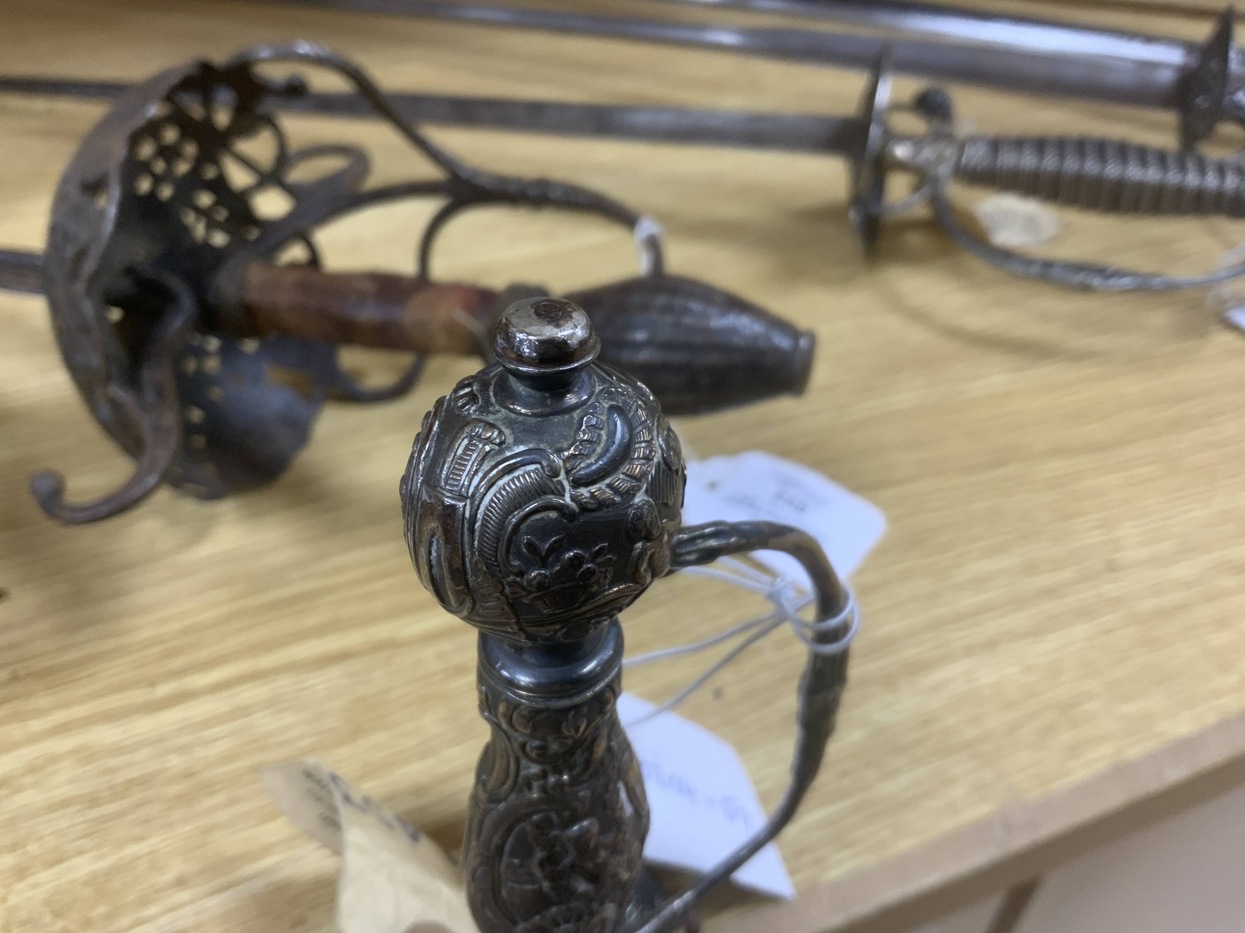 A French silver hilted small sword, c.1770, the guard, pommel and grip all chiselled with putti, flowers and rococo devices, blade etched with commensurate designs with retaining traces of gilding, blade 74cm